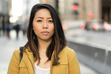 Young Asian woman in city serious face portrait - obrazy, fototapety, plakaty
