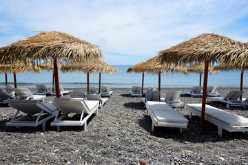 The beach with black volcanic stones at Santorini island, Greece