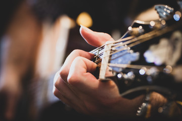 Playing classic guitar. Selective focus.