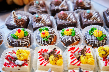 Assortment of pieces of cake on table, copy space. Several slices of delicious desserts, restaurant menu concept