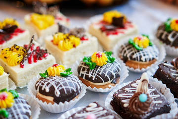 Assortment of pieces of cake on table, copy space. Several slices of delicious desserts, restaurant menu concept