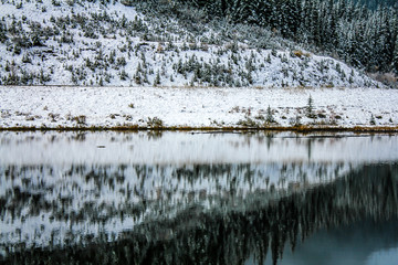Early snow covers the hills by the lake, Sibbald Lake Provincial Recreation Area, Alberta, Canada