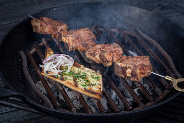 juicy, fried, tender steak with vegetables and sauces on a special stand