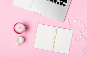 Workspace of freelancer, blogger, journalist - laptop, notepad, pen, cup of trendy superfood pink...