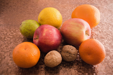 Fruits, apples, oranges, tangerines, pears, walnuts.