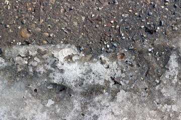Melting snow asphalt stone grit slush road
