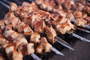 Grilling marinated shashlik on a grill. Shashlik is a form of Shish kebab popular in Europe and other places