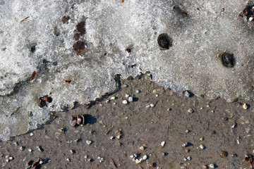 Melting snow asphalt stone grit slush road