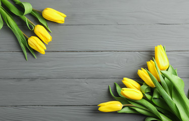 Beautiful yellow tulip flowers on wooden background. Space for text