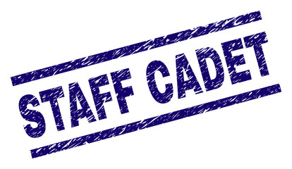 STAFF CADET seal print with grunge style. Blue vector rubber print of STAFF CADET text with grunge texture. Text label is placed between parallel lines.