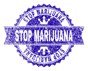 STOP MARIJUANA rosette seal watermark with distress texture. Designed with round rosette, ribbon and small crowns. Blue vector rubber watermark of STOP MARIJUANA label with corroded texture.