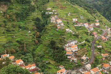 Fototapeta na wymiar Landscape Of Steps / An image showing how steps have been cut into the mountainous landscape so that local people can grow their crops shot at Machico, Madeira, Portugal.
