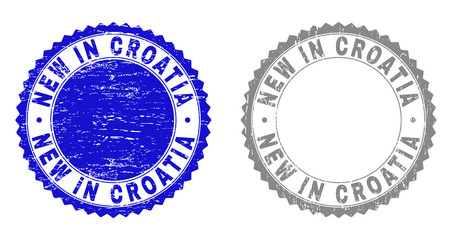 Grunge NEW IN CROATIA stamp seals isolated on a white background. Rosette seals with grunge texture in blue and gray colors. Vector rubber stamp imprint of NEW IN CROATIA caption inside round rosette.