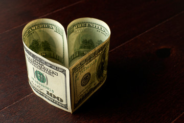 Heart made of us dollars banknotes. - 248518630