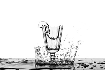 A photograph of a splash in alcohol in a vintage glass. - 248518860