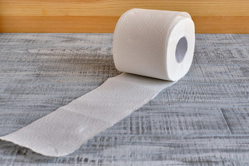 roll of toilet paper on a wooden background