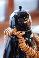 Russian traditional painted samovar with delicious herbal tea and donuts