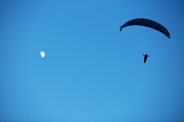silhouette of paraglider in the sky