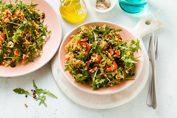 rice salad with baked bell peppers, arugula, olives and capers. Healthy vegan spring recipe for the whole family or party