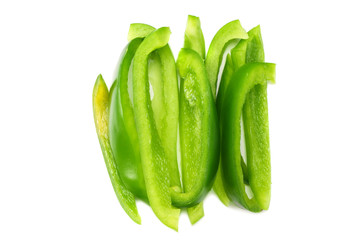 cut slices of green sweet bell pepper isolated on white background top view
