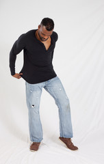 Thoughtful Black man in a black shirt and jeans