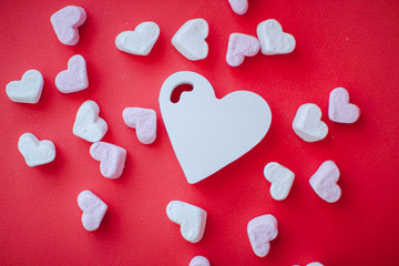 Sweets in the shape of a heart on a red background. Valentine's Day