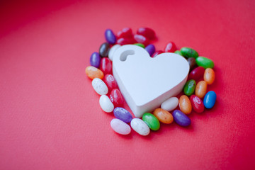 Sweets in the shape of a heart on a red background. Valentine's Day