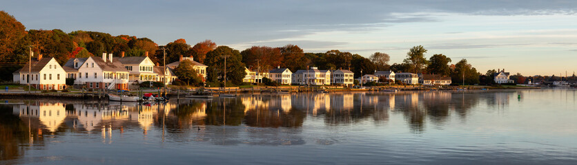 Panoramic view of residential homes by the Mystic River during a vibrant sunrise. Taken in Mystic, Stonington, Connecticut, United States.