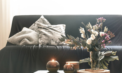 Cozy home interior living room with a vase of flowers and candles