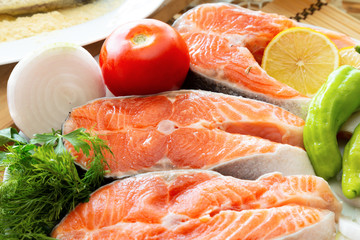 salmon with lemon and spices on wooden table