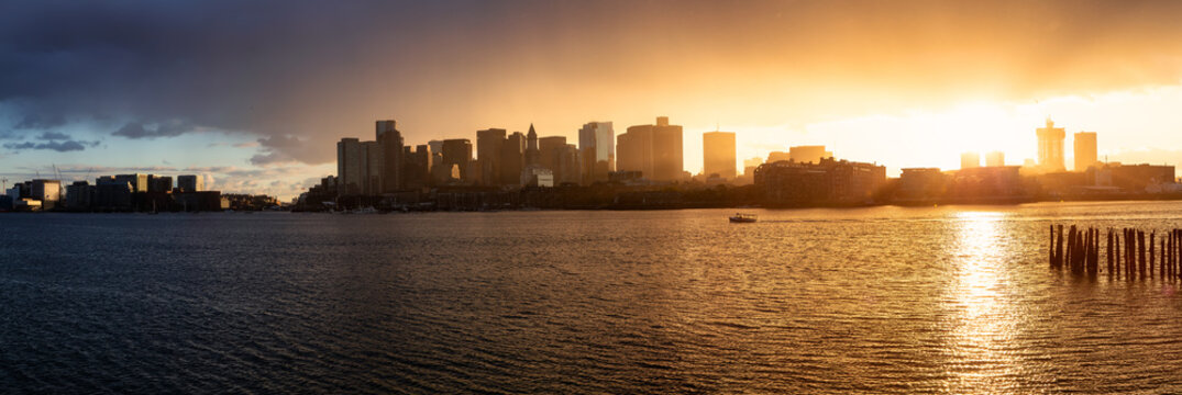 Striking panoramic cityscape of a modern Downtown City during a vibrant sunset. Taken from LoPresti Park, Boston, Capital of Massachusetts, United States.