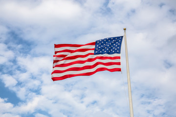 American Flag on the Cloudy background.