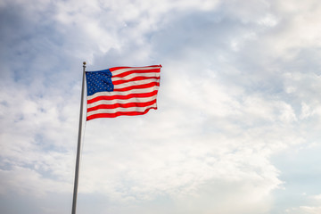 American Flag on the Cloudy background.