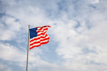 American Flag on the Cloudy background.