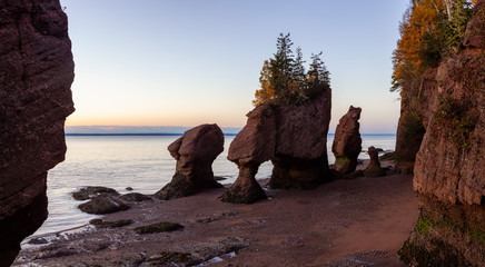 Panoramic view of Cape Rocks during a vibrant sunrise. Taken in Hopewell Rocks Park, New Brunswick,...