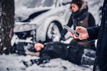 The witness of the accident keeps the phone and is going to call the rescue service. The car got...