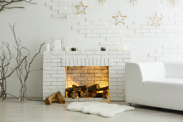 White fireplace in light room with Christmas decoration