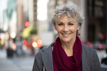 Mature woman in city smile happy face portrait