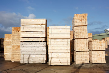 Wood chips pellets chopped wooden logsand stacked wooden pallets for biomass fuel at sawmill