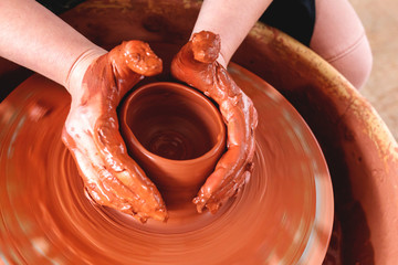Professional potter making bowl in pottery workshop