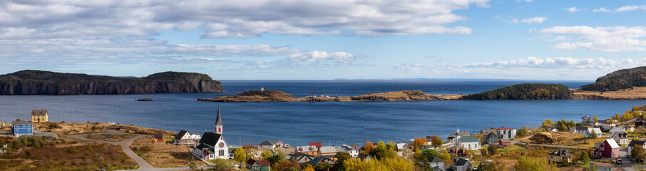 Fototapeta na wymiar Aerial panoramic view of a small town on the Atlantic Ocean Coast during a sunny day. Taken in Trinity, Newfoundland and Labrador, Canada.
