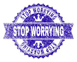 STOP WORRYING rosette seal imprint with grunge texture. Designed with round rosette, ribbon and small crowns. Blue vector rubber print of STOP WORRYING title with grunge texture.