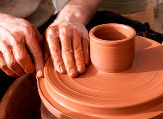 Professional potter making bowl in pottery workshop