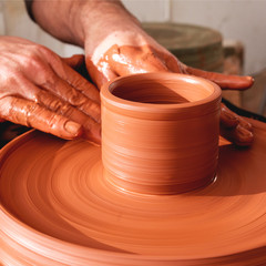 Professional potter making bowl in pottery workshop