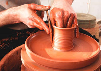 Professional potter making bowl in pottery workshop
