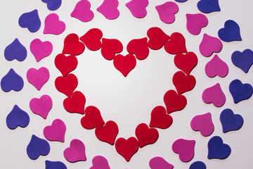 Valentine's day background. Colored little hearts on a white background. Copyspace.