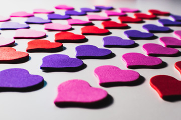 Obraz na płótnie Canvas Valentine's day background. Colored little hearts on a white background.