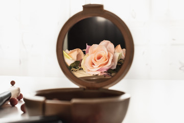 pink flower in blush mirror reflection