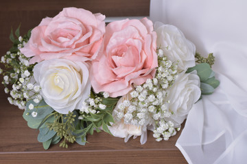 close up of a beautiful wedding bouquet of flowers on a wooden surface 