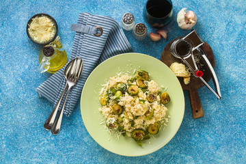 Italian spring risotto with Brussels sprouts and parmesan cheese on the table. healthy food for the whole family, party or restaurant menu